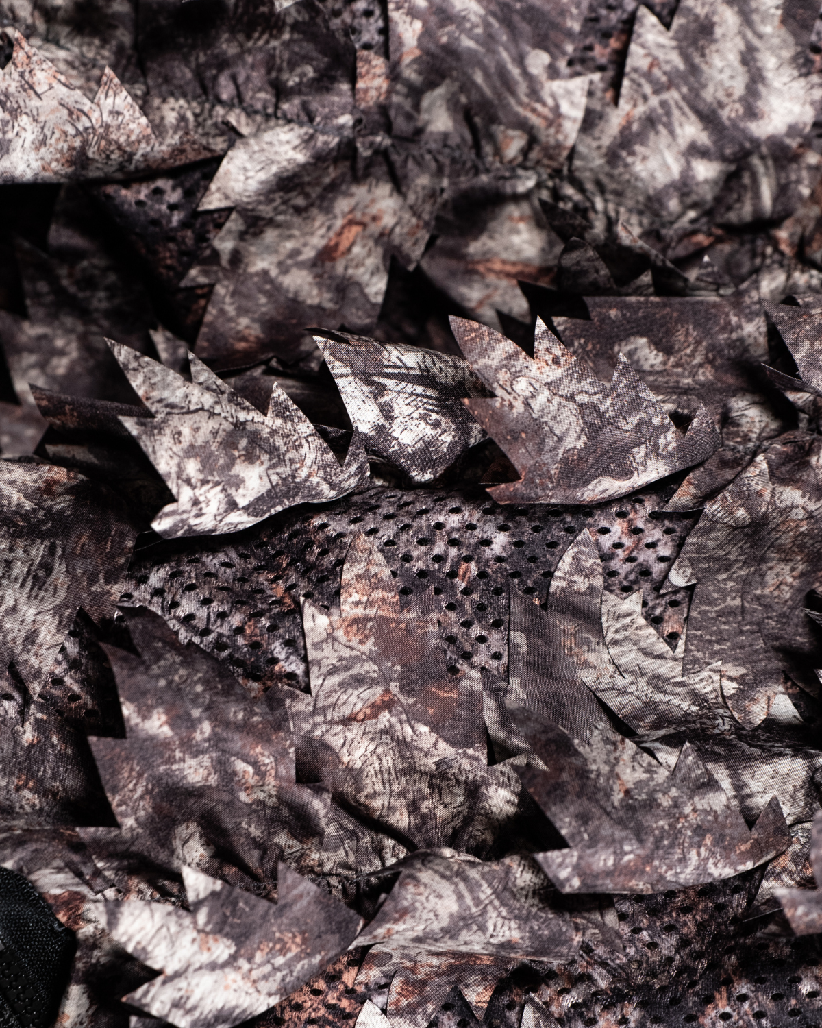 ASIO Gear Raptor camo leafy jacket close up showing 3D leaf cut fabric and breathable mesh construction