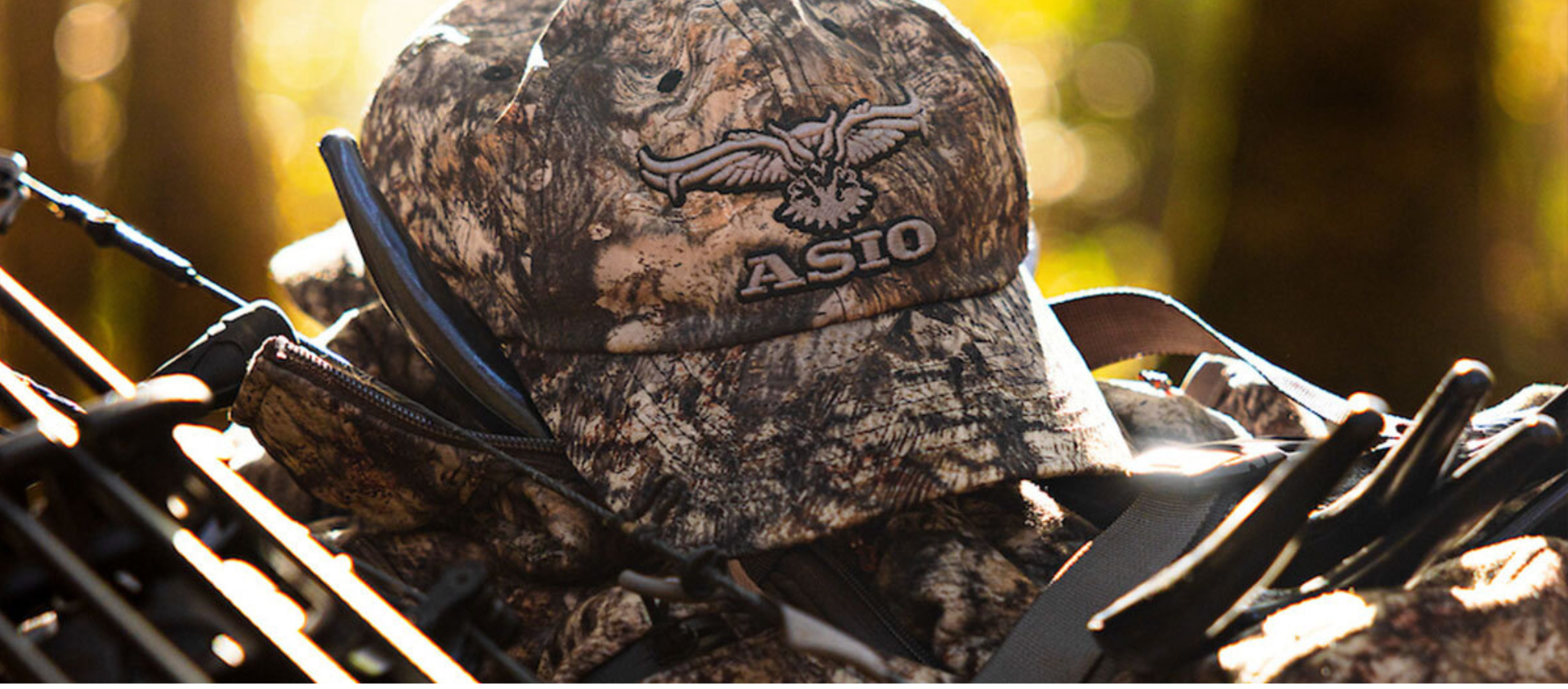 asio gear lightweight camo hat in raptor displayed with sunset in back