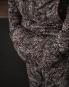 ASIO Gear handmuff worn at the waist in Raptor camo, showing sleek front pocket design in natural lighting.