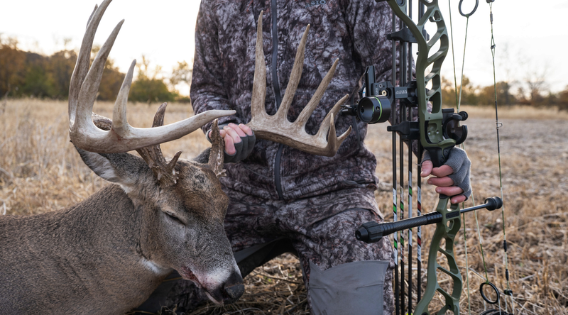 Bowhunter wearing ASIO Gear technical hunting apparel after harvesting a mature whitetail deer.