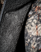 Close up of the ASIO Gear Midweight Sherpa Jacket showing the soft sherpa fleece interior designed for warmth during cold weather bowhunting.