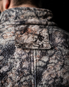 Rear view of the ASIO Gear Midweight Sherpa Jacket featuring a concealed tree harness pass through port for safe and comfortable treestand hunting.